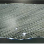 Figure 1 Pores inside the weld seam of the 2 mm specimen (15×)